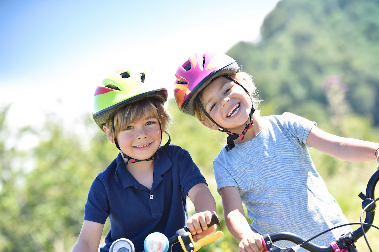 kids on bikes with helmets